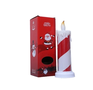 Detail view of red striped Christmas LED candle light with Merry Christmas gift box