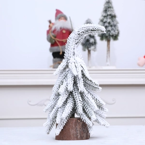Décoration de sapin de Noël courbé avec neige artificielle sur socle en bois naturel