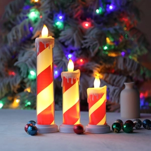 Three-piece LED flameless candle set with red and white candy cane stripes and dripping wax effect