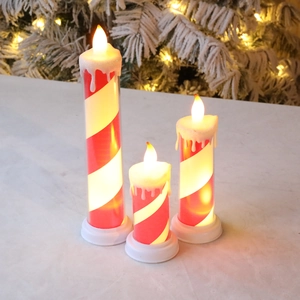 Three-piece LED flameless Christmas candles with red and white candy cane stripes