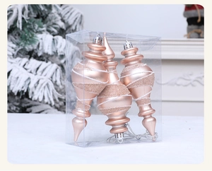 Three champagne gold spiral ornaments in a clear box with a matte and glitter finish