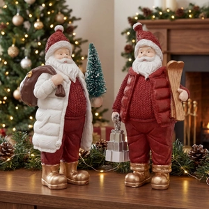 Resin Santa figurines holding a gift bag, Christmas tree, and skis for festive decor