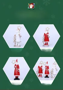 Close-up of resin Santa Claus figurines with golden star staff and tree for desk decor