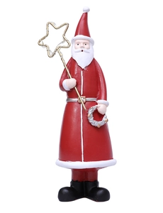 Detailed view of Santa figurine holding a lit golden star staff and silver wreath decoration