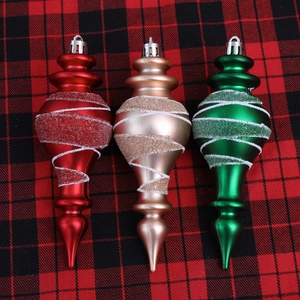 Three-piece finial Christmas ornaments in red gold and green with white glitter spirals