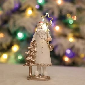 Red resin Santa figurine with glowing star and golden tree for Christmas table decor