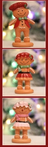 Detailed view of three resin gingerbread man figurines with festive outfits and scarves