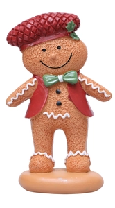 Detailed close-up of a gingerbread man figurine with a red hat and festive green bow tie