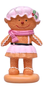 Detail of gingerbread woman figurine in pink festive outfit on orange round base
