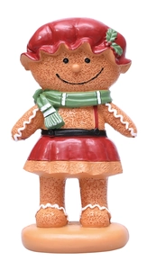 Detailed view of gingerbread person figurine with red hat and green scarf on base