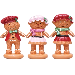 Three gingerbread person figurines set in resin with realistic cookie texture