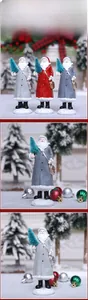 Detailed view of hand-painted resin Santa figurines with gift bags and mini trees