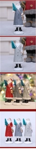 Detailed view of resin Santa statues with green mini trees and snowy textured bases