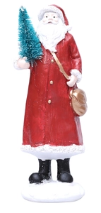 Macro view of Santa Claus figurine detail with gift bag and small green tree decoration