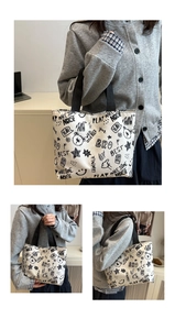Detail view of graffiti canvas tote bag showing street art prints and black woven handles