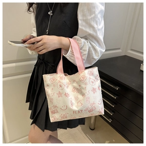 Detail of white graffiti tote bag with pink straps and hand-drawn bear patterns