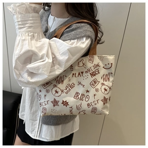 Close-up of cute brown bear graffiti print on large white canvas shoulder tote bag
