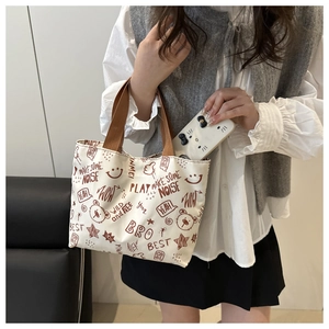 Detail of the large capacity canvas tote bag showing interior space with a smartphone