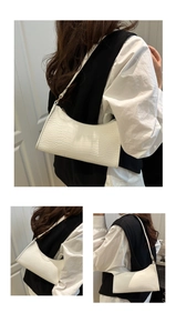 Detailed close-up of white baguette bag showing luxury faux crocodile embossed leather texture