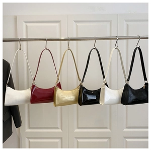 Selection of crescent shoulder bags in glossy patent and crocodile embossed textures