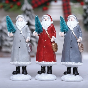 Three resin Santa Claus figurines in gray red and blue holding mini green Christmas trees