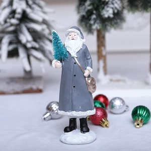 Grey Santa figurine holding a mini tree with golden shoulder bag and snow base ornament