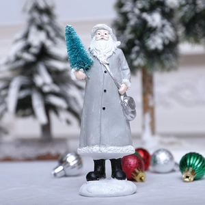 Silver Santa Claus resin figurine holding a green flocked tree for Christmas decor