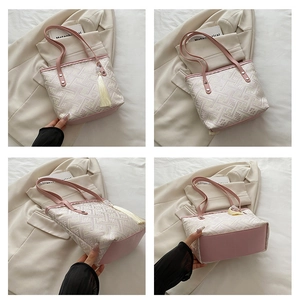 Detail view of pink and beige jacquard tote bag with traditional floral patterns