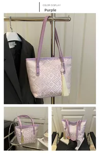 Detail of purple jacquard bucket bag with traditional pattern, tassel and PU strap