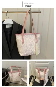 Detailed view of pink Chinese style embroidery tote bag with tassel and geometric pattern