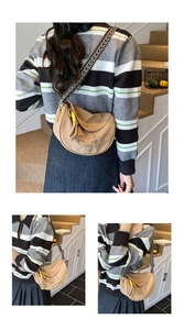 Detail of beige half-moon bag with Love yourself embroidery and striped woven strap