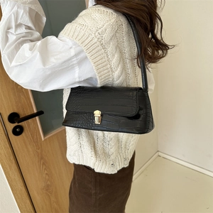 Minimalist black crocodile pattern shoulder bag with a gold metal clasp for women