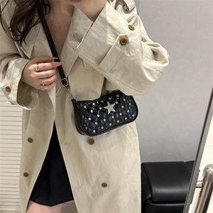 Quilted black patent leather crossbody bag with rhinestone star and adjustable strap