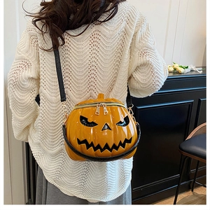 Detailed view of the 3D pumpkin shoulder bag with glossy finish and black strap