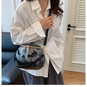 Close-up of Halloween pumpkin bag showing silver brushed texture and gold dual zippers