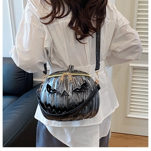 Model view of pumpkin shaped crossbody bag with 3D face design and metallic texture