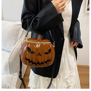Detail of Jack-O-Lantern pumpkin shaped crossbody bag with gold zippers and leather finish
