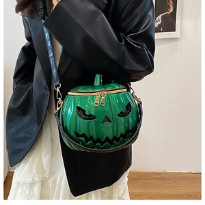 Detail of bright green pumpkin crossbody bag with black crocodile texture strap