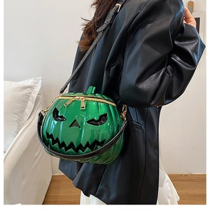Detail of green pumpkin crossbody bag featuring glossy patent leather and gold zippers