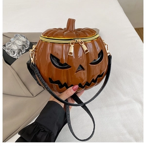 Detail of creative 3D pumpkin shoulder bag with glossy finish and gold zipper closure