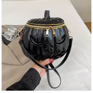 Detail of the shiny black patent leather pumpkin bag with 3D face and gold zippers