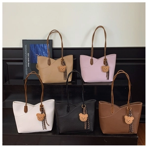 Five assorted solid-color tote bags with teddy bear charms and litchi grain texture