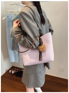 Pale pink lychee grain leather tote bag with brown straps and cute bear pendant charm
