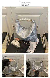 Detail of silver snake-pattern bag with pearl beaded handle and fine gold chain