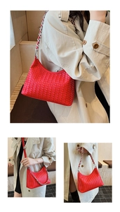 Detail of red woven leather shoulder bag with silver chain strap on model