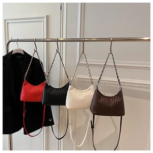 Detail of woven hobo bags in red, black, white, and brown with metallic chains