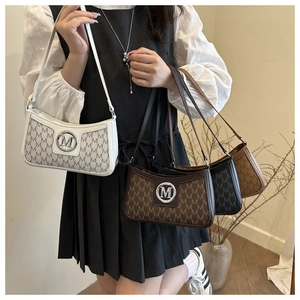 Fashionable underarm bags with M-monogram pattern and metallic logo shown by a model