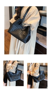 Detailed close-up of premium black woven leather tote showing intricate craft textures