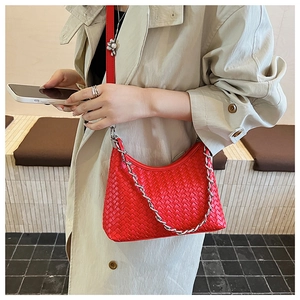 Detailed shot of a red woven hobo bag featuring a silver chain and sleek leather strap