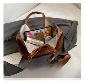 Detail view of brown woven leather tote bag showing large interior capacity with accessories
